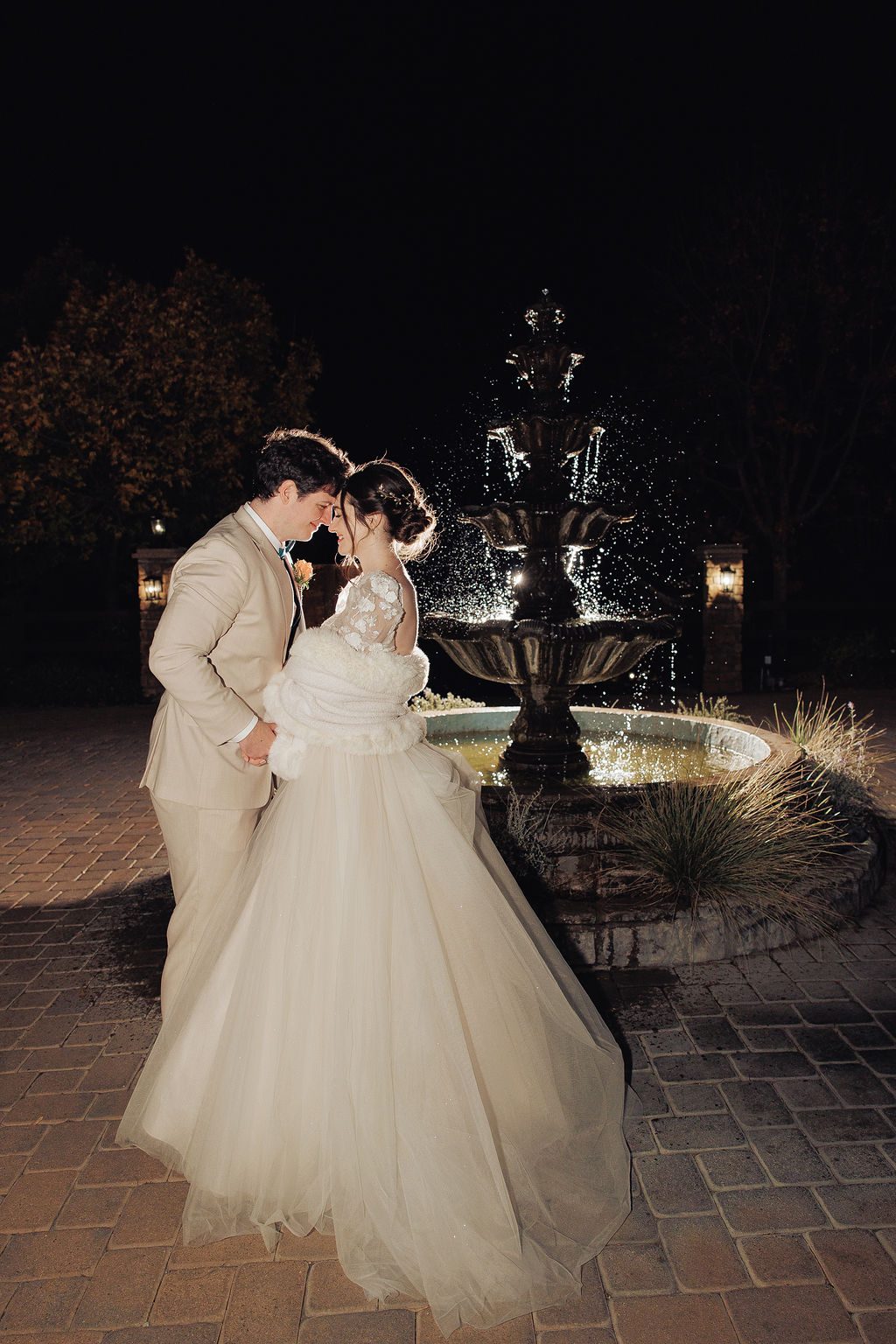 Evening wedding portrait by a lit fountain | Precious Pics Production